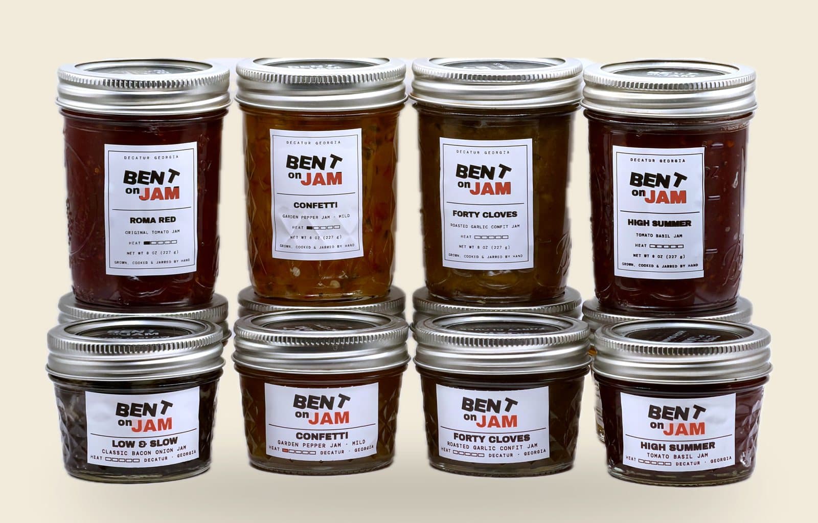 The whole range on the bench — 8 oz jars behind, 4 oz in front